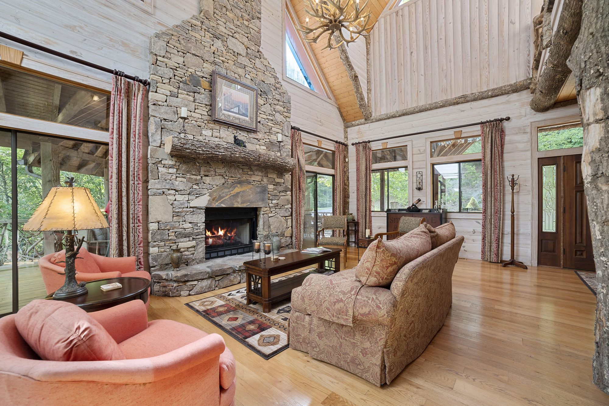 Great room with antler chandelier and hand-hewn timber trusses
