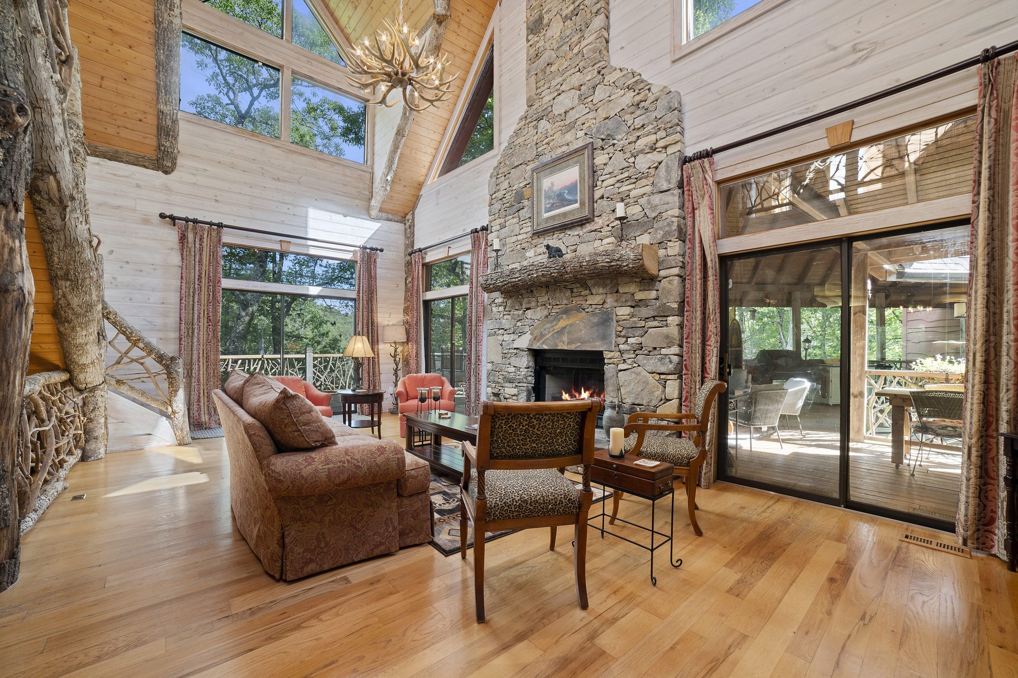 Great room seating area beneath cathedral log ceilings
