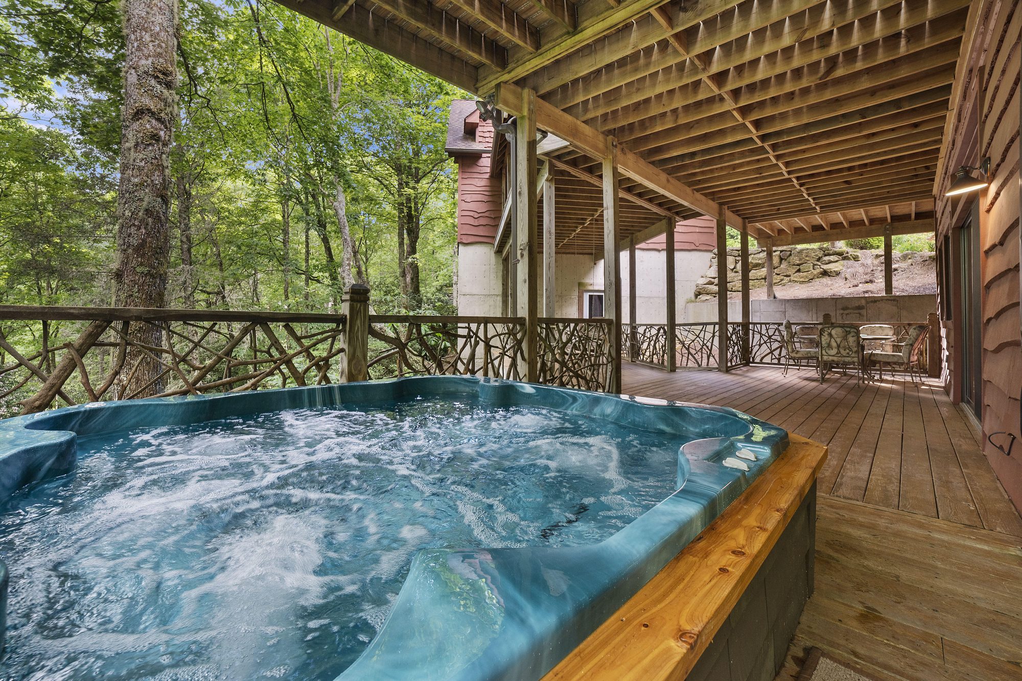 Hot tub steaming on the deck beneath the trees