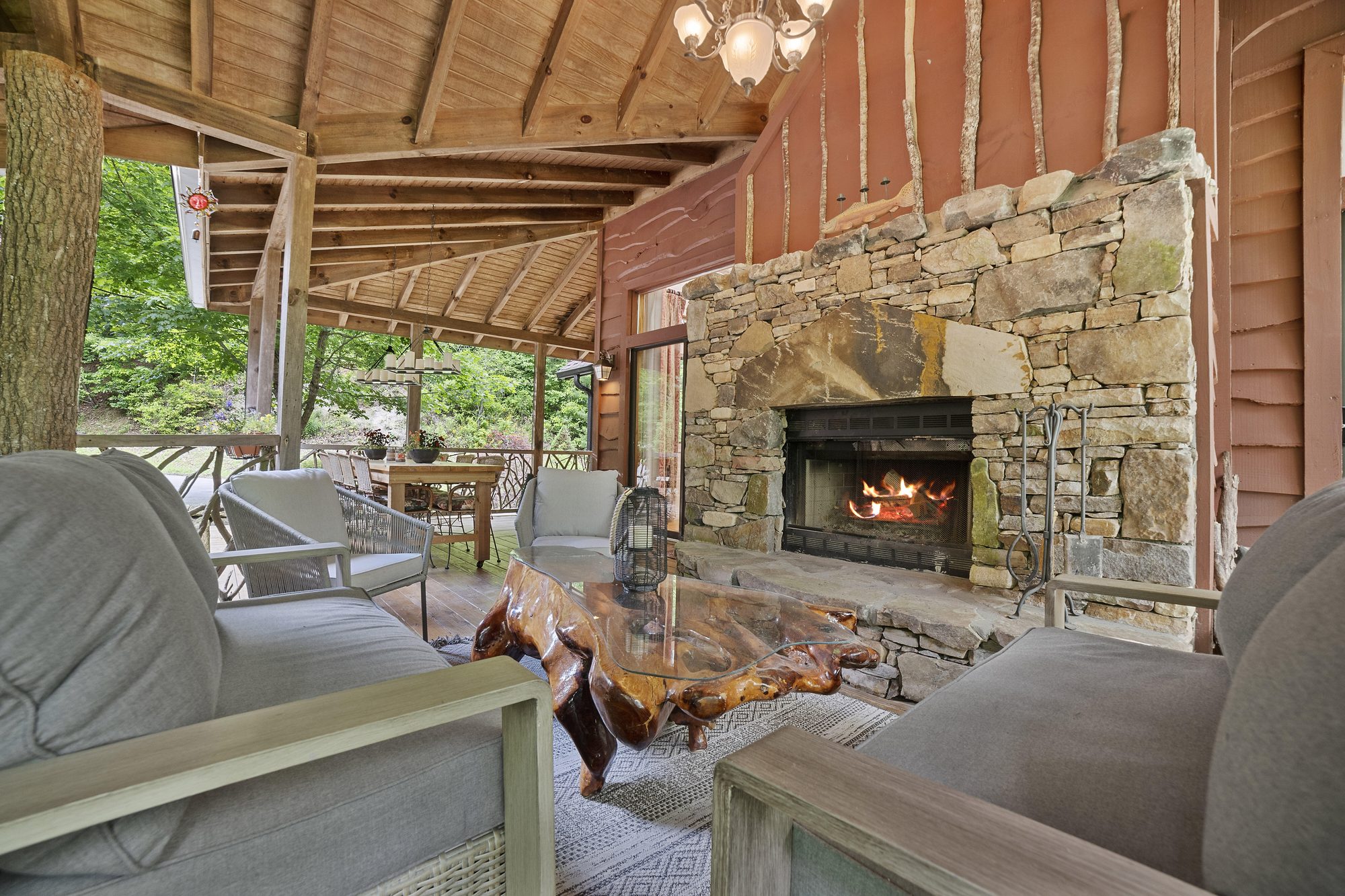 Outdoor stone fireplace on the covered deck