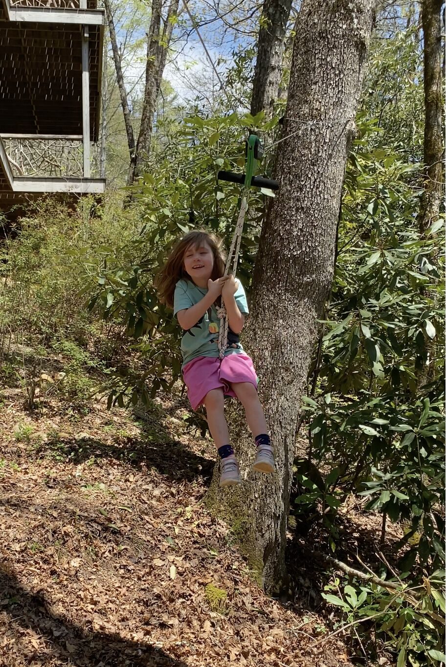 Children playing on the zip line in the back yard